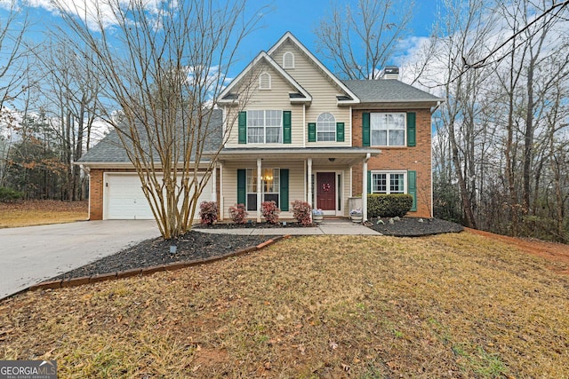 view of front facade featuring a garage, a front lawn, and covered porch