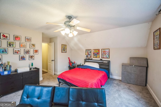 bedroom featuring ceiling fan, lofted ceiling, light colored carpet, and a textured ceiling