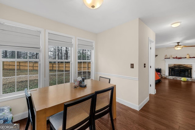 dining room with dark hardwood / wood-style flooring and ceiling fan