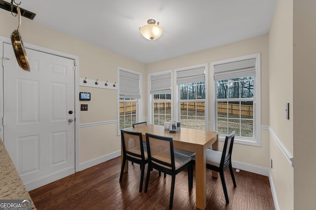 dining room with plenty of natural light and dark hardwood / wood-style floors