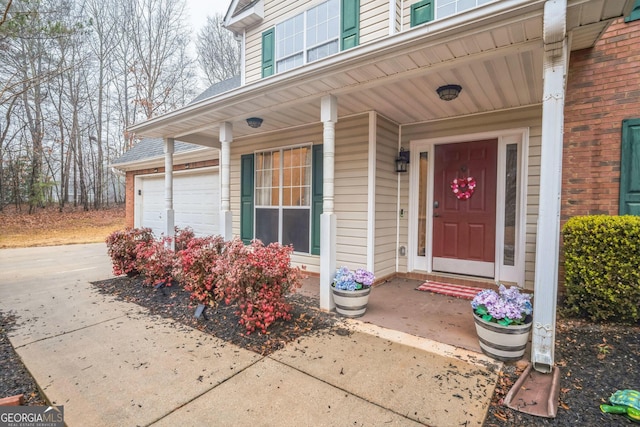 doorway to property with a garage