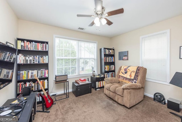 sitting room featuring ceiling fan and light carpet