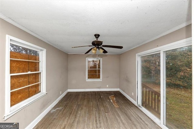 unfurnished room featuring wood-type flooring, crown molding, ceiling fan, and a textured ceiling