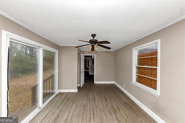 unfurnished room with crown molding, ceiling fan, hardwood / wood-style floors, and a textured ceiling