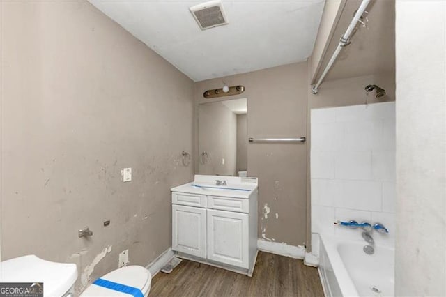 full bathroom with shower / bathtub combination, vanity, toilet, and wood-type flooring