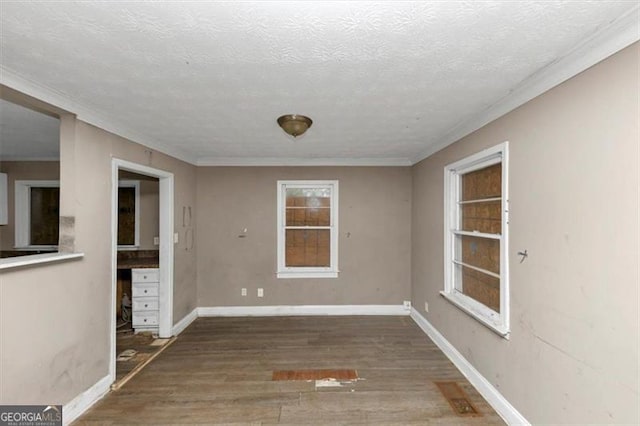 unfurnished dining area featuring ornamental molding, dark hardwood / wood-style floors, and a textured ceiling