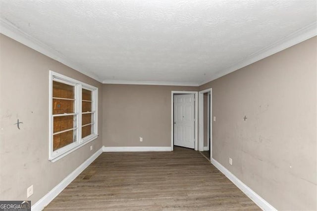 unfurnished room featuring wood-type flooring, a textured ceiling, and crown molding