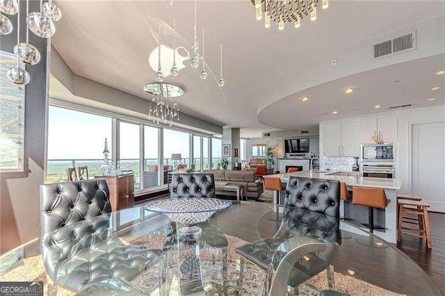 dining room with a chandelier and hardwood / wood-style floors