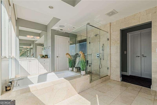 bathroom with vanity and separate shower and tub