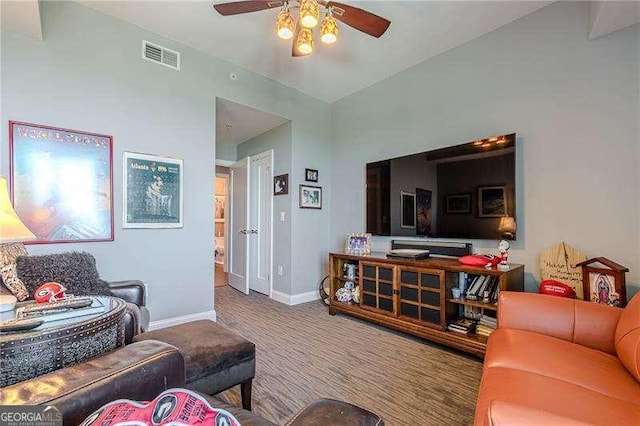 carpeted living room featuring ceiling fan and lofted ceiling