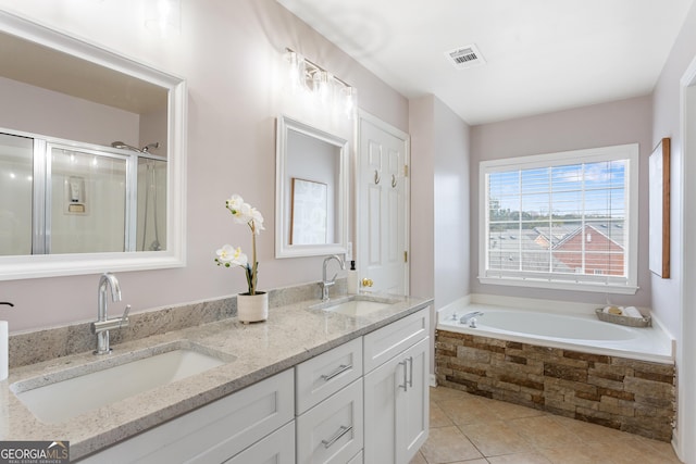 bathroom with tile patterned flooring, vanity, and independent shower and bath