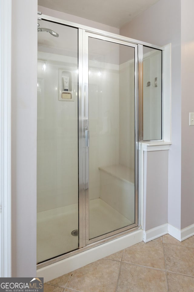 bathroom featuring an enclosed shower and tile patterned flooring