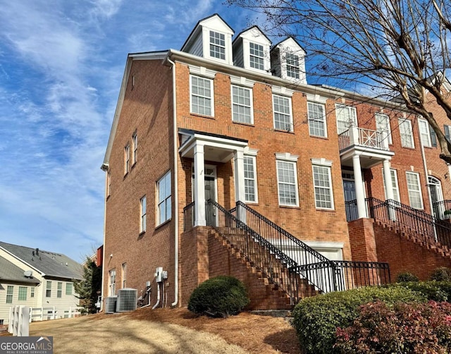 view of front of property featuring central AC unit and a garage