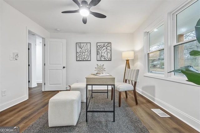 home office featuring dark hardwood / wood-style floors and ceiling fan