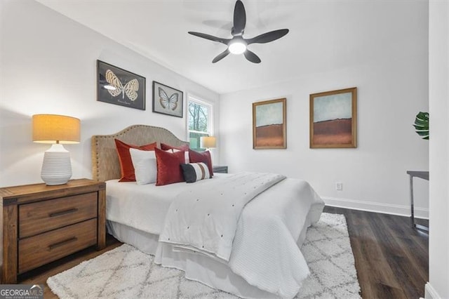 bedroom with dark hardwood / wood-style floors and ceiling fan