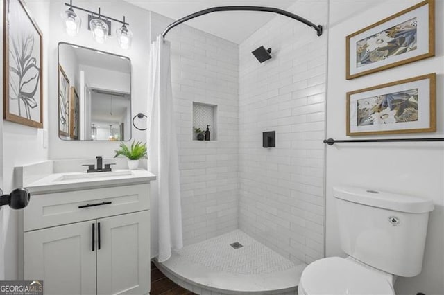 bathroom featuring a shower with curtain, vanity, and toilet