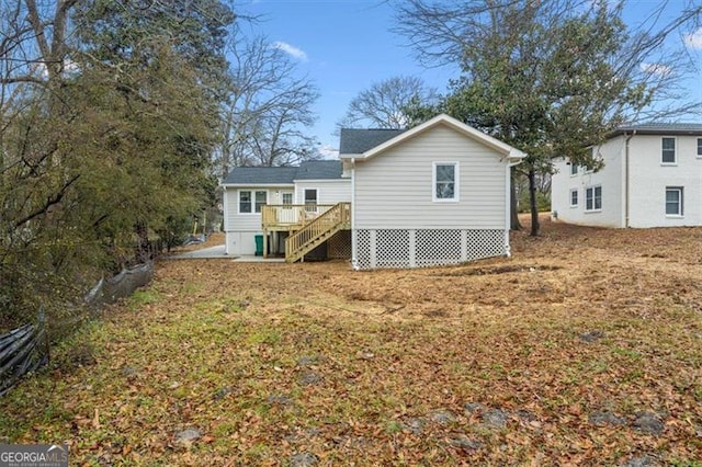 back of house featuring a yard and a deck