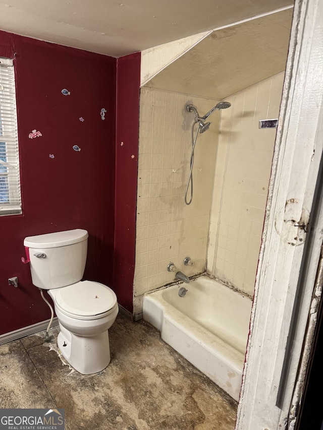 bathroom featuring tiled shower / bath and toilet