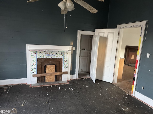 unfurnished living room with ceiling fan