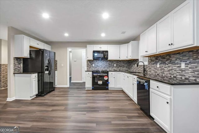 kitchen with sink, white cabinetry, dark hardwood / wood-style floors, tasteful backsplash, and black appliances