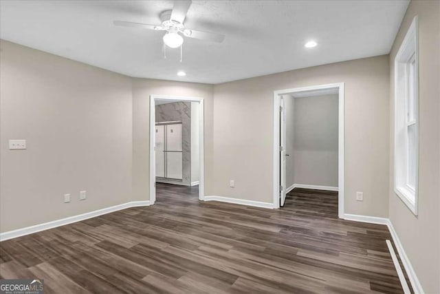 spare room featuring dark hardwood / wood-style floors and ceiling fan