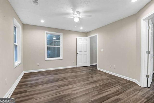 unfurnished room featuring dark hardwood / wood-style floors and ceiling fan