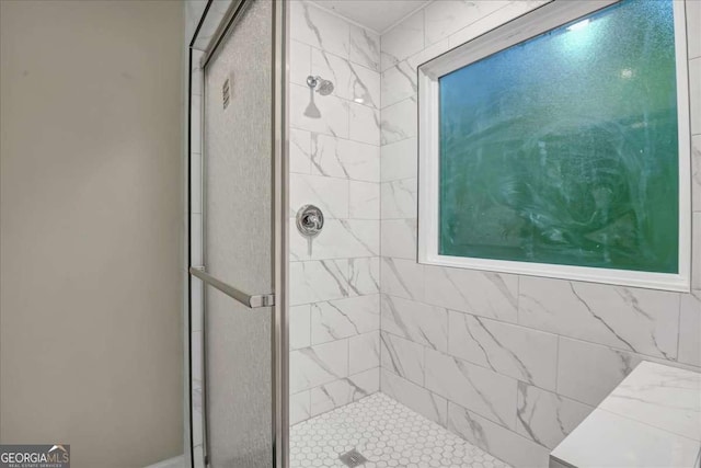 bathroom with a shower with shower door