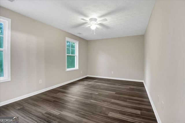 spare room featuring a textured ceiling, dark hardwood / wood-style floors, and ceiling fan