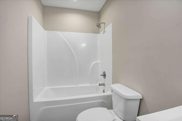 bathroom featuring  shower combination and toilet