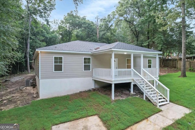 view of front of home with a porch, central AC unit, and a front lawn