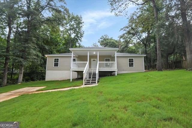 rear view of property with a yard and covered porch