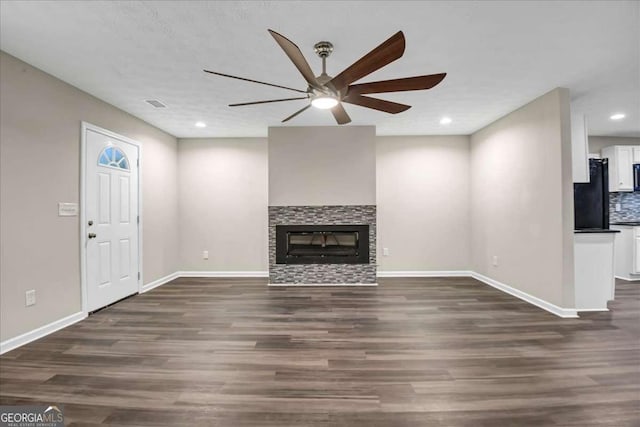 unfurnished living room with dark wood-type flooring and ceiling fan