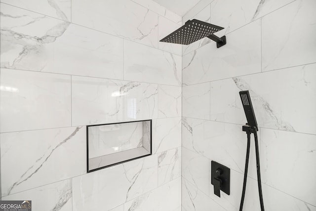 interior details featuring tiled shower