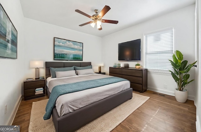 bedroom with hardwood / wood-style floors and ceiling fan