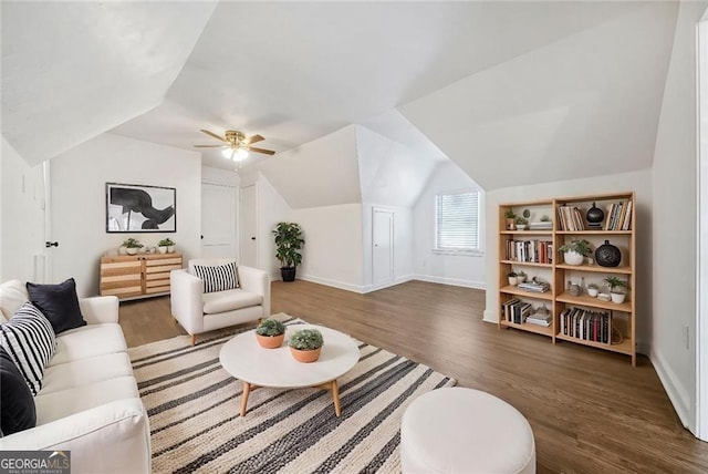 living room featuring dark wood-type flooring, ceiling fan, and lofted ceiling