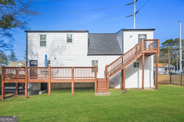 back of property with a wooden deck and a lawn