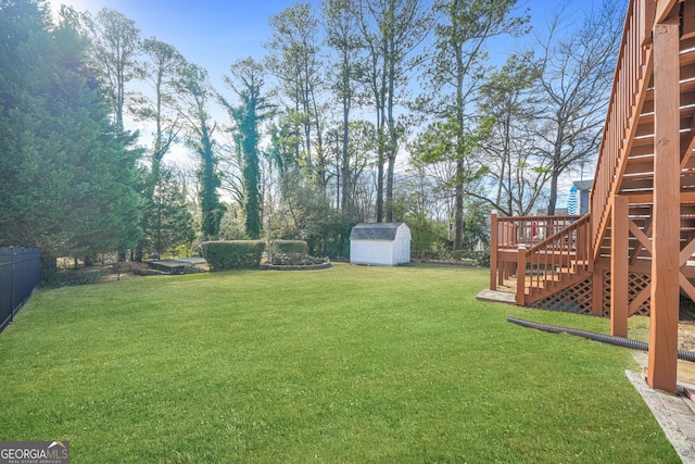 view of yard with a deck and a shed