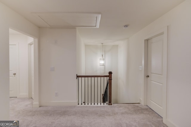 corridor featuring light colored carpet