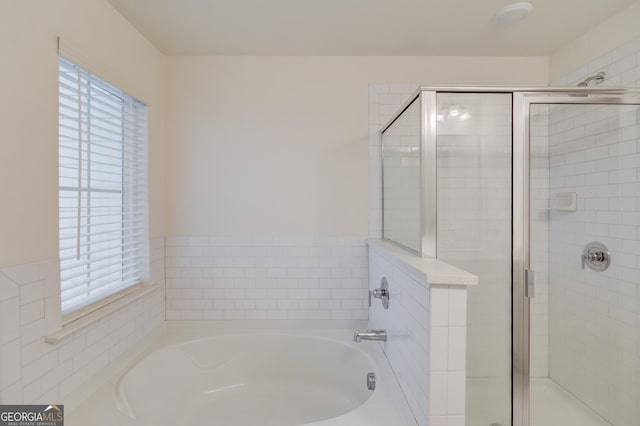 bathroom with separate shower and tub