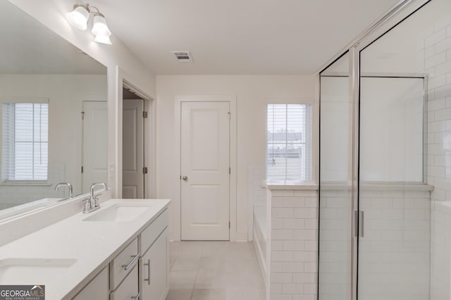 bathroom with tile patterned floors, separate shower and tub, and vanity