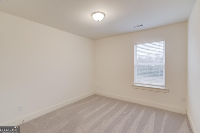 spare room with light colored carpet