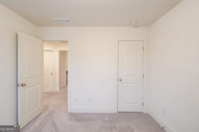 unfurnished bedroom featuring light colored carpet