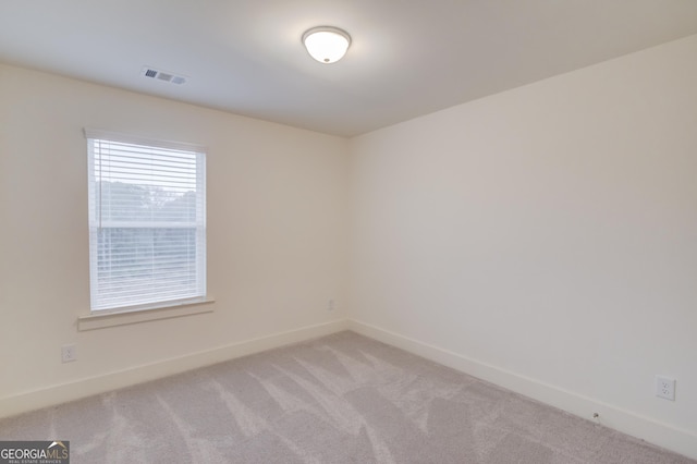 spare room with light carpet