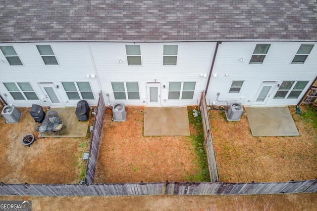 rear view of property featuring central AC and a patio area