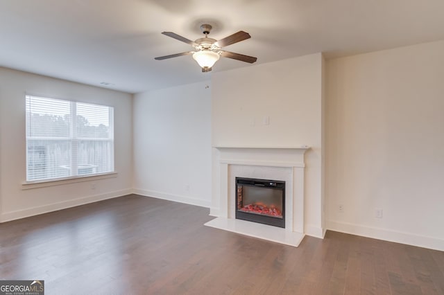 unfurnished living room featuring dark hardwood / wood-style floors and ceiling fan