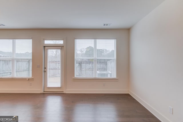 entryway with dark wood-type flooring and plenty of natural light