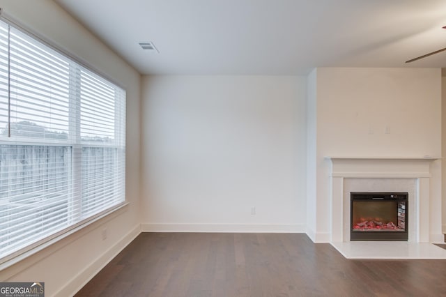 unfurnished living room with dark hardwood / wood-style flooring