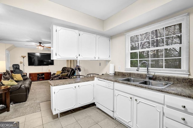 kitchen featuring white cabinetry, white dishwasher, kitchen peninsula, and sink