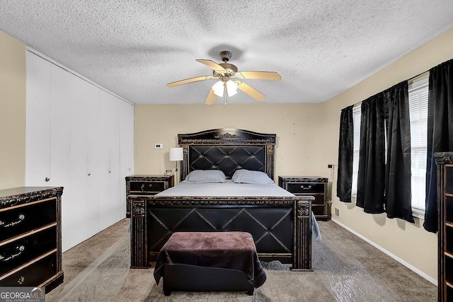 bedroom with multiple windows, a textured ceiling, and ceiling fan