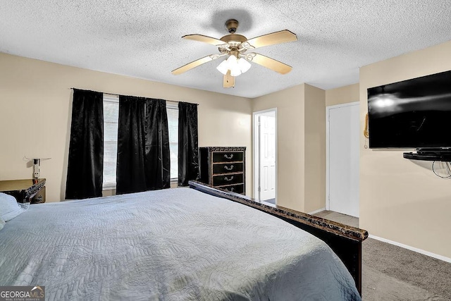 bedroom with ceiling fan, a textured ceiling, and carpet